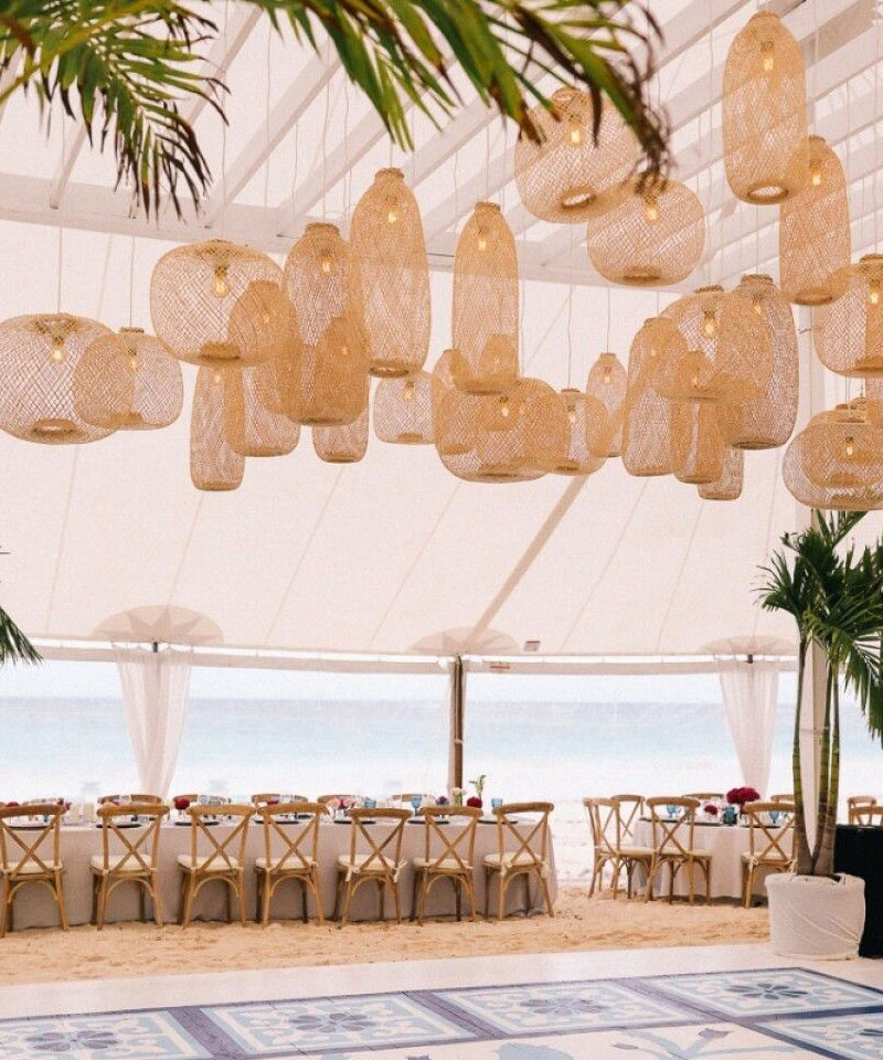 An elegant wedding lighting vibe with a cluster of bamboo pendant lights.