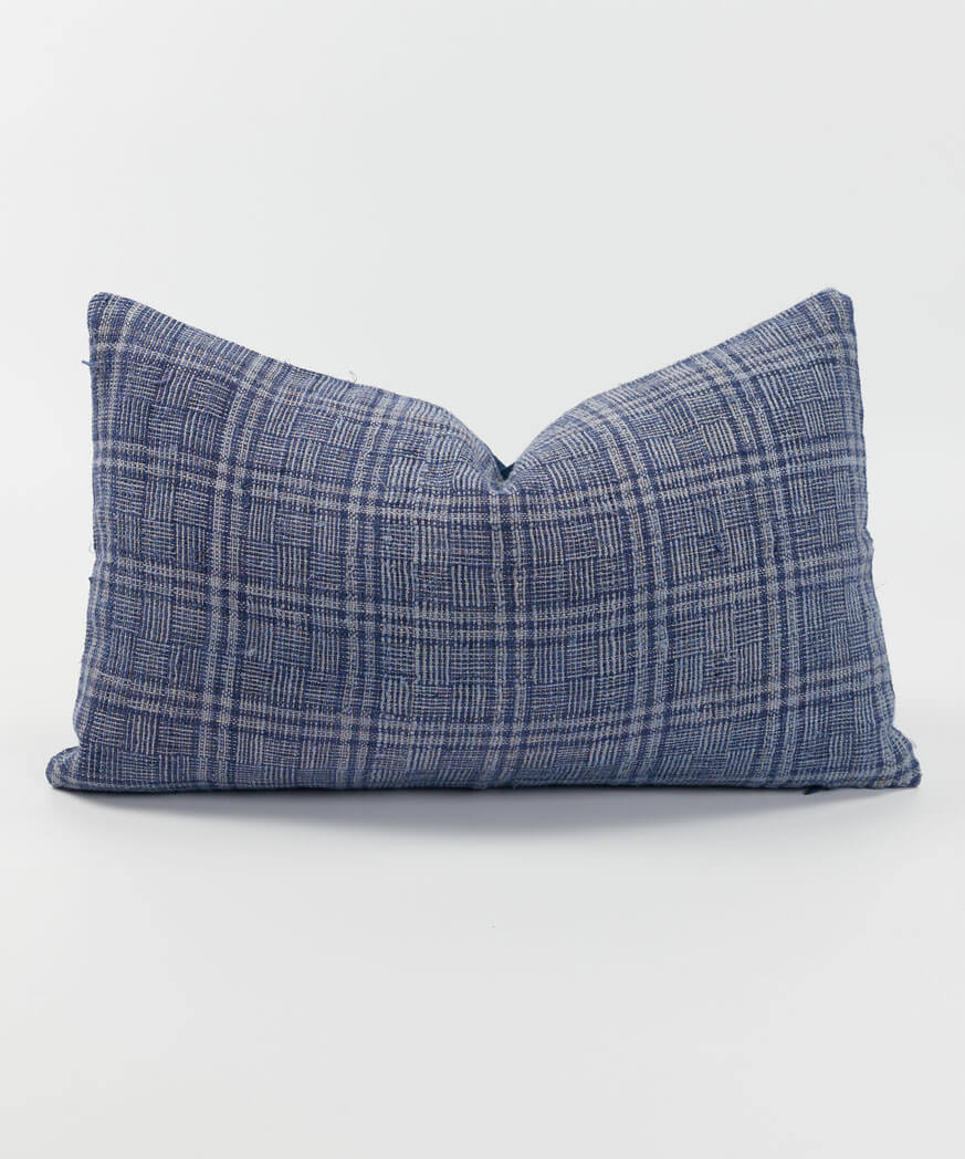 A blue plaid cushion featuring a hemp textile.