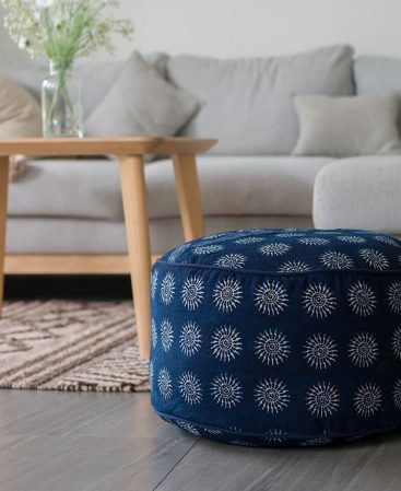 A bohemian floor pouf featuring indigo batik fabric from the Hmong hill tribe.