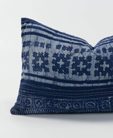 A close up showing tribal motifs and violet indigo colors on this cushion cover.