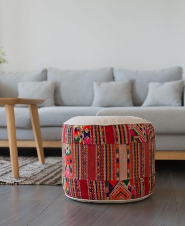 A colorful patchwork ottoman pouf cushion.