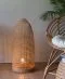 A large standing floor lamp made from bamboo and rattan.
