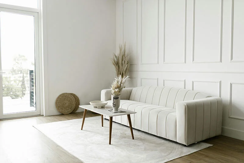 A minimalist living room with wall art ready to hang.