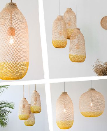 A mix of natural wood and yellow color pendant lighting shades in various sizes.