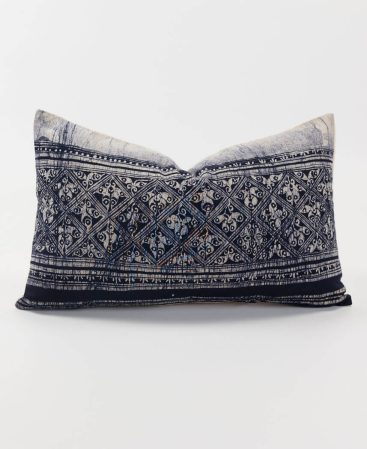 A monochrome cushion design with dark indigo dye staining and ethnic fabric charm.