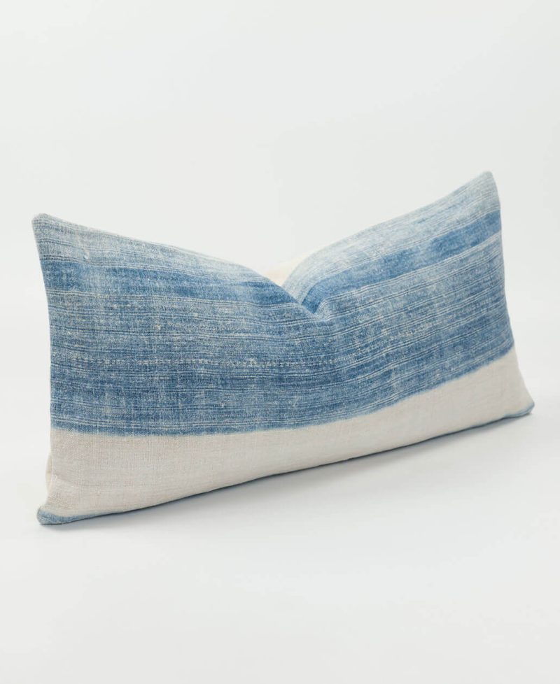 A rectangle-shaped indigo cushion cover with a white stripe design.