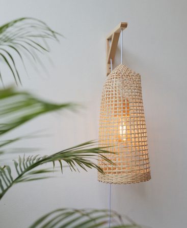A rustic boho wall sconce-style lamp made with bamboo.