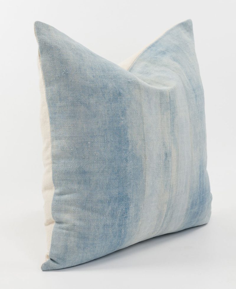 A rustic hemp cushion with blue and white tones.