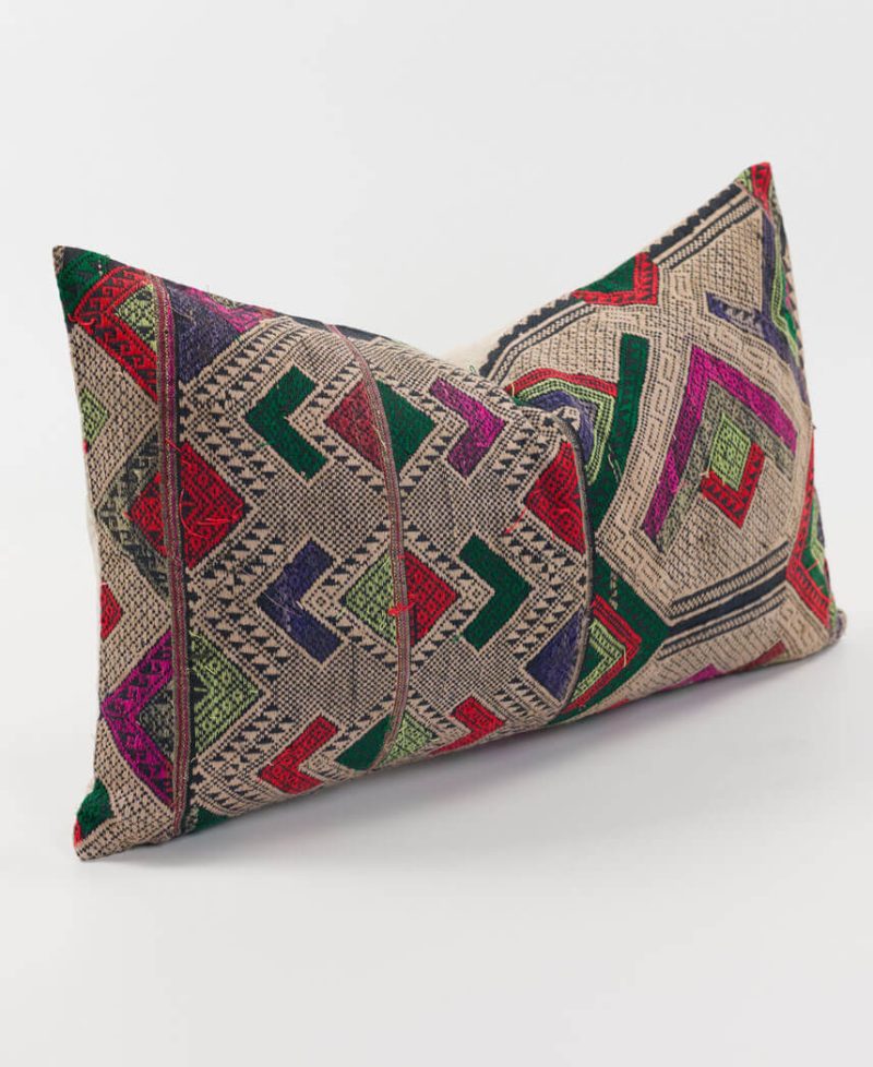 A side view of a silk and cotton lumbar cushion.