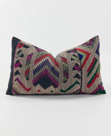 A vintage cotton and silk pillow cover made with tribal textiles.