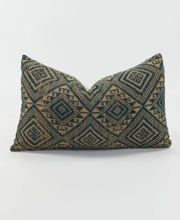 A vintage kilim fabric cushion cover with indigo and bronze hues.