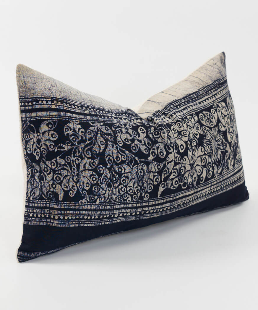 An ethnic fabric throw cushion pillow in gray color.
