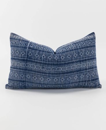 An ethnic pillow cover with indigo dye staining.