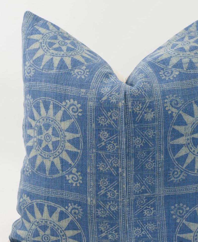 An ethnic pillow cover with sun designs.