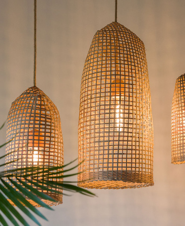 Artisan crafted boho lighting fixtures hanging alongside each other.