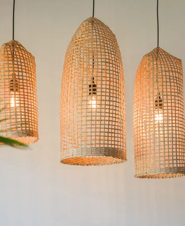 Artisan crafted bamboo rattan light fixture with black cords.