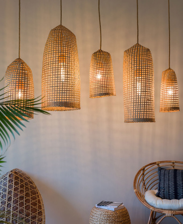 Boho lighting fixtures using traditionally woven trap baskets.