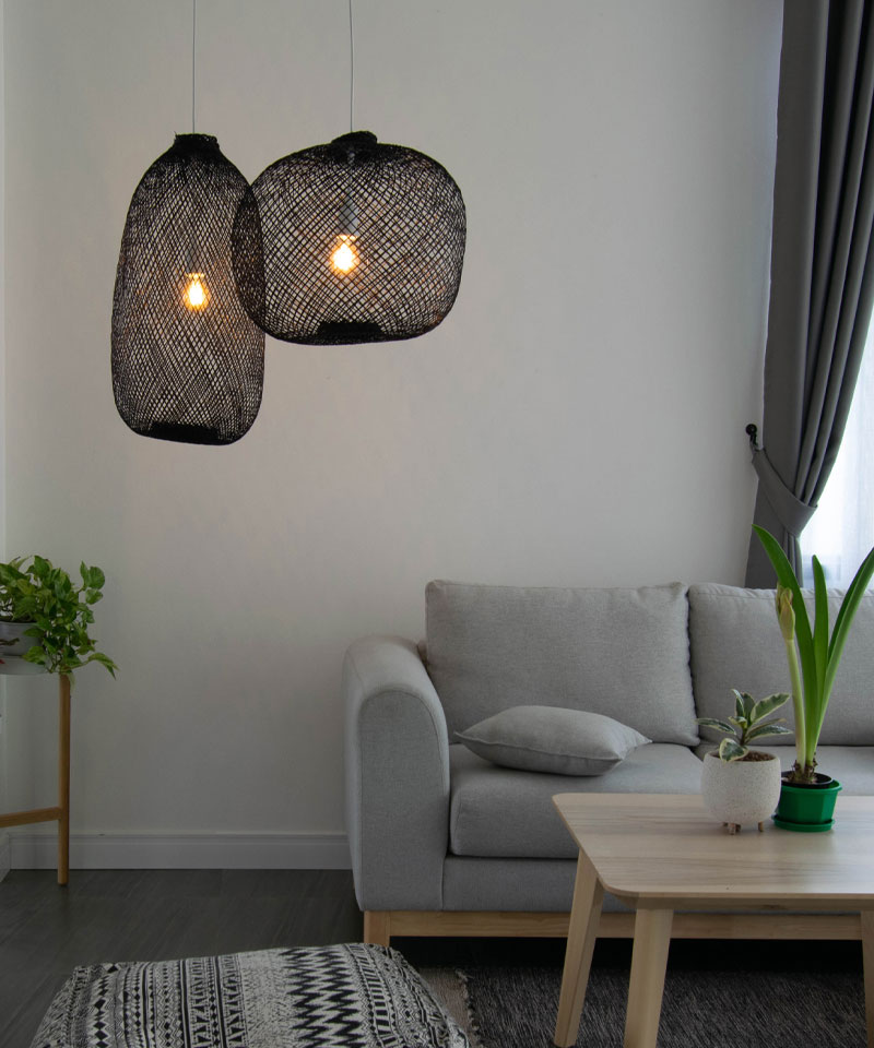 A rustic black pendant light, handcrafted from bamboo for an elegant and natural light fixture.