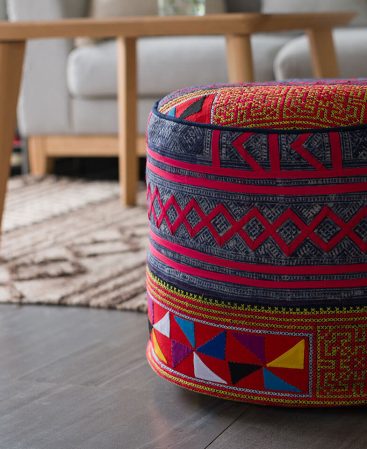 Close up of an ethnic ottoman pouf with embroidered patterns.
