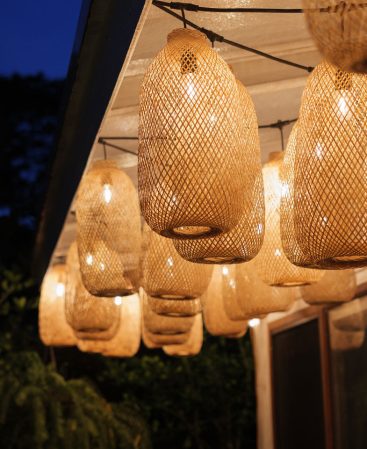Close up of outdoor bamboo rattan basket string lights.