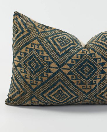 Close up view of a kilim inspired pillow cover with golden brown hues.