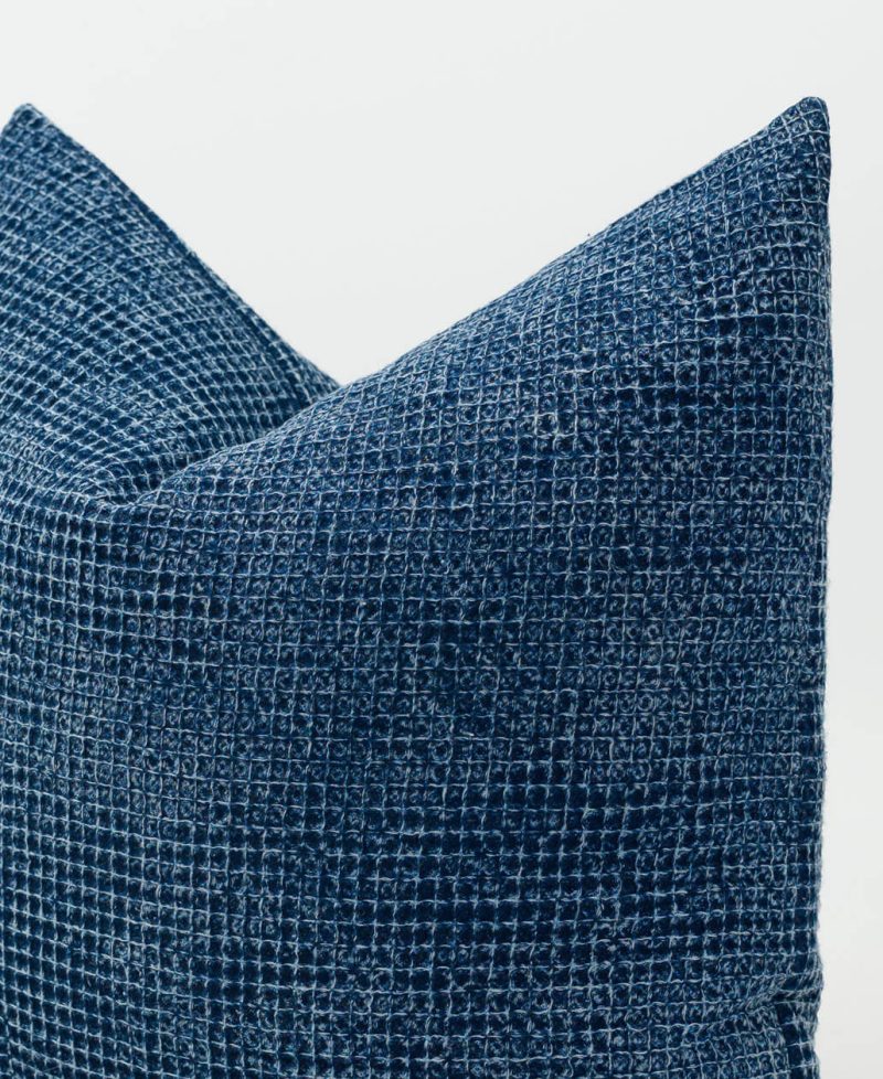 Close view of a textured rustic stonewash fabric cushion cover.