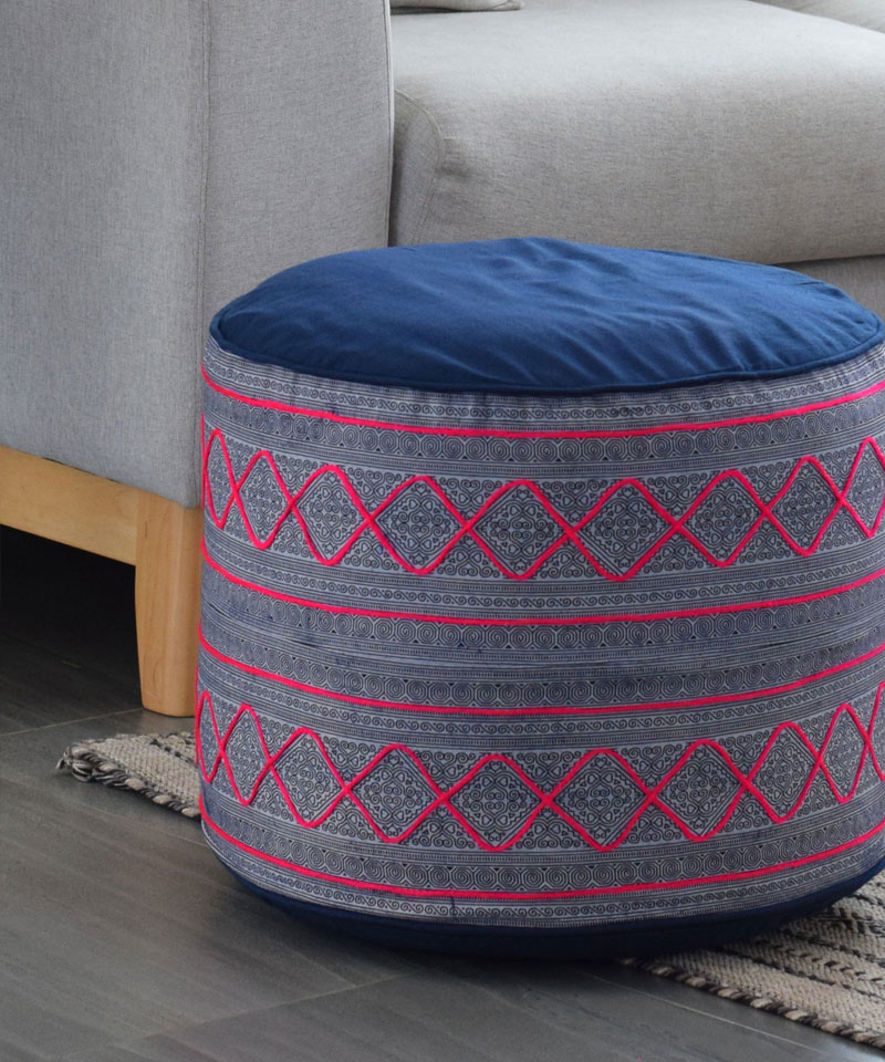A large indigo and hot pink ottoman made from hill tribe batik textiles.