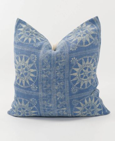 Ethnic fabric pillow cover with sun motifs.