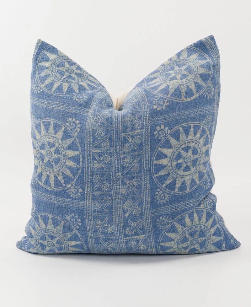 Ethnic fabric pillow cover with sun motifs.