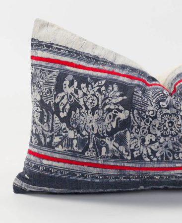 Faded indigo batik fabric makes up the front of this cushion cover.