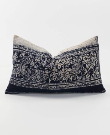 Grey and black throw cushion made from ethnic textiles.