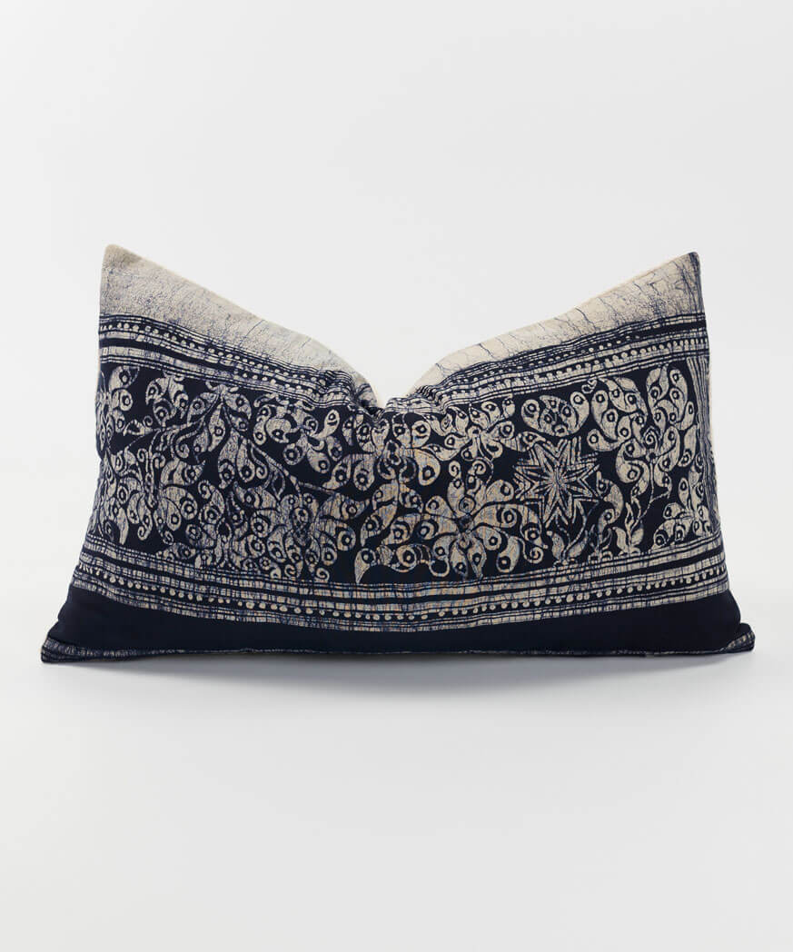 Grey and black throw cushion made from ethnic textiles.