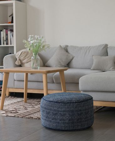 Large indigo batik floor cushion in a living space.
