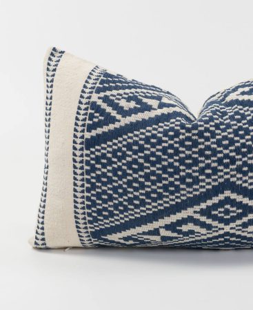 Loosely woven indigo cotton threads create geometric shapes on this cushion.