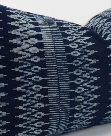 Lumbar pillow with a white and blue batik design.