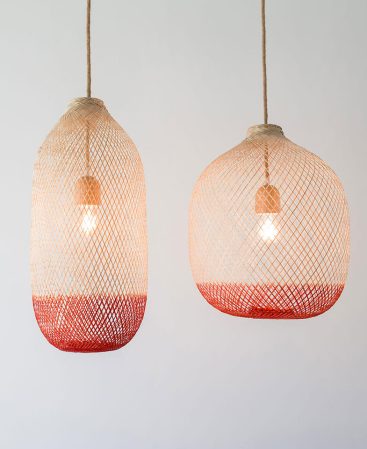 Natural wood and rust-orange copper color light fixtures with rope light cords and vintage bulbs.