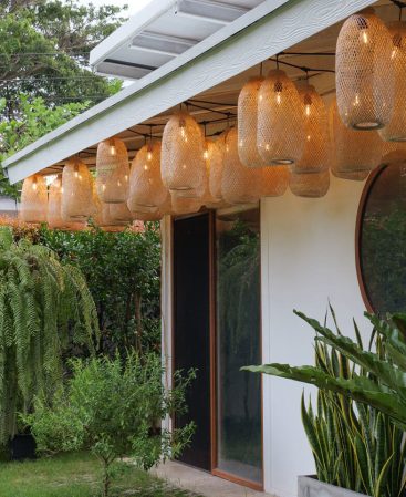 Outdoor bamboo garden decor lighting set with hanging baskets.