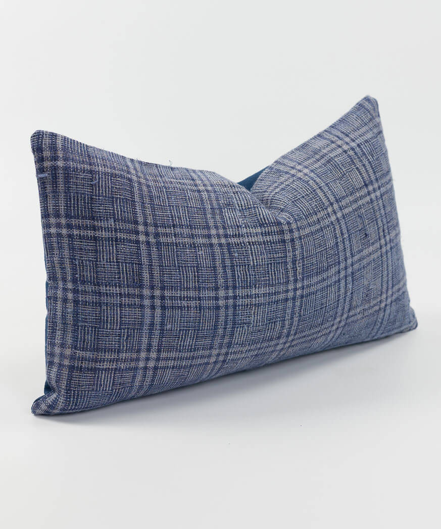 Side view of a vintage hemp cushion with indigo dyed strands.