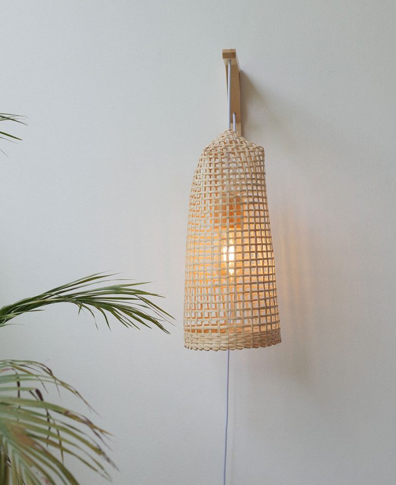 Tall, rustic bamboo wood wired wall sconce light fixture.