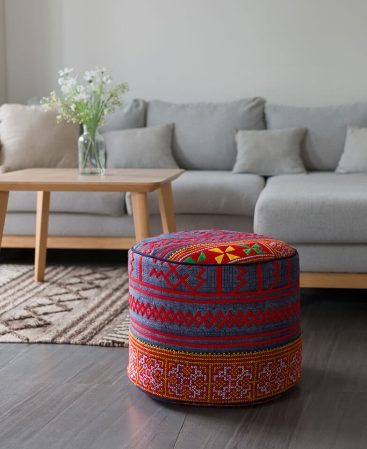 This ottoman features indigo batik hemp with colorful embroidery.