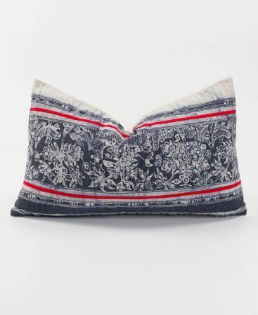 Tribal cushion cover with indigo batik and red stripes.