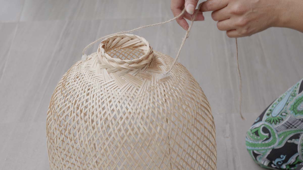 Two cord stoppers shown on either side of a bamboo basket.