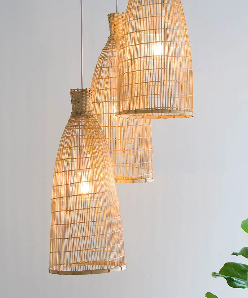 Close Up of Three Tall Bamboo Pendant Shades Hanging In A Cluster